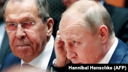 Russian President Vladimir Putin and Foreign Minister Sergei Lavrov listen during a Libya summit in Berlin on January 19.