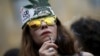 A woman smokes during a rally in support of the decriminalization of marijuana in Tbilisi in 2015.