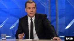 Russian Prime Minister Dmitry Medvedev answers questions from journalists during his live interview to Russia's leading television channels on December 6.