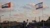 Women wearing face masks against the coronavirus walk past United Arab Emirates and Israeli flags at the Peace Bridge in Netanya, Israel, Sunday, Aug. 16, 2020. 