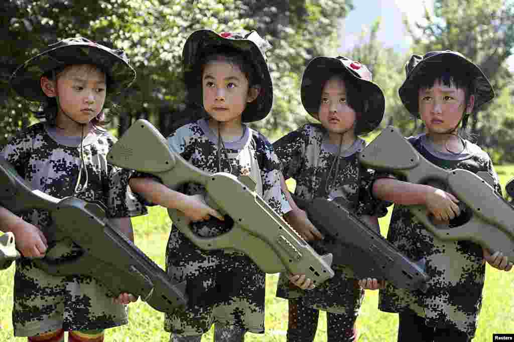 Chinese children, holding toy guns, participate in an event to simulate military training at a children&#39;s activity center in Shenyang, in Liaoning Province. (Reuters/Stringer)
