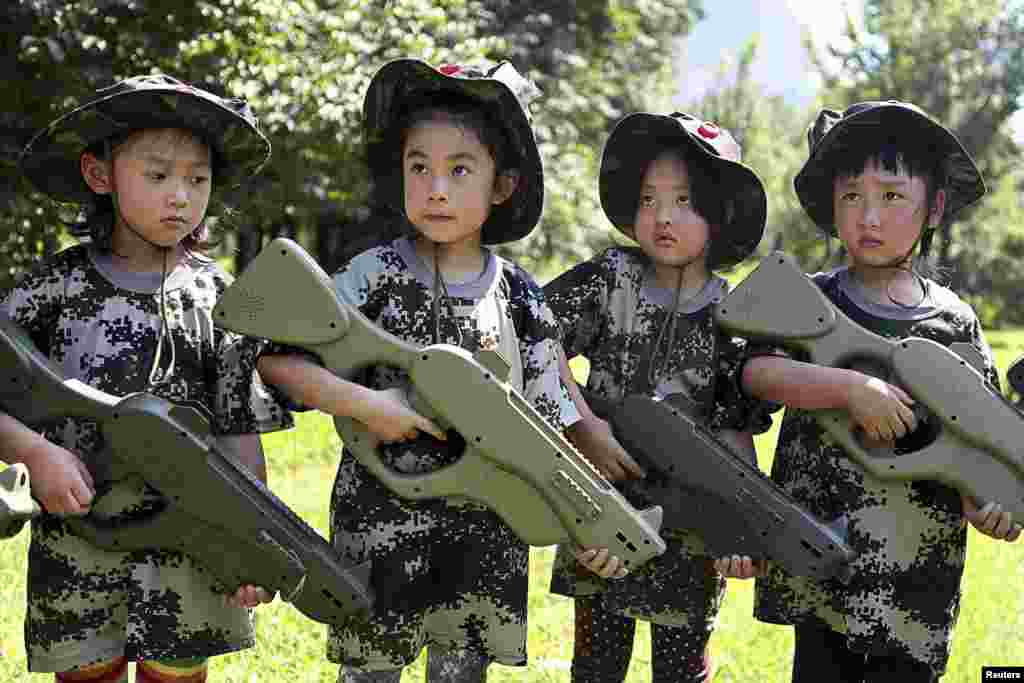 Chinese children, holding toy guns, participate in an event to simulate military training at a children's activity center in Shenyang, in Liaoning Province. (Reuters/Stringer)