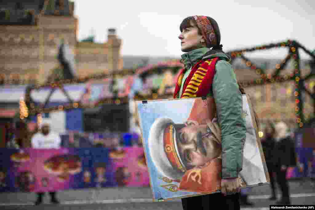 An artist holds a portrait of former Soviet leader Josef Stalin outside GUM, the state department store, in Moscow&#39;s Red Square. Communist supporters marked the anniversary of Stalin&#39;s birth on December 21. (AP/Alexander Zemlianichenko)