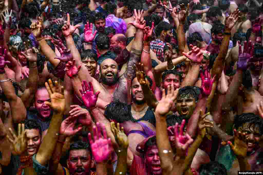 Revelers dance as they celebrate Holi, the spring festival of colors, in Allahabad, India. (AFP/Sanjay Kanojia)​