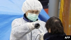 Medical staff check radiation levels of residents of the city of Koriyama in Fukushima Prefecture on March 13.