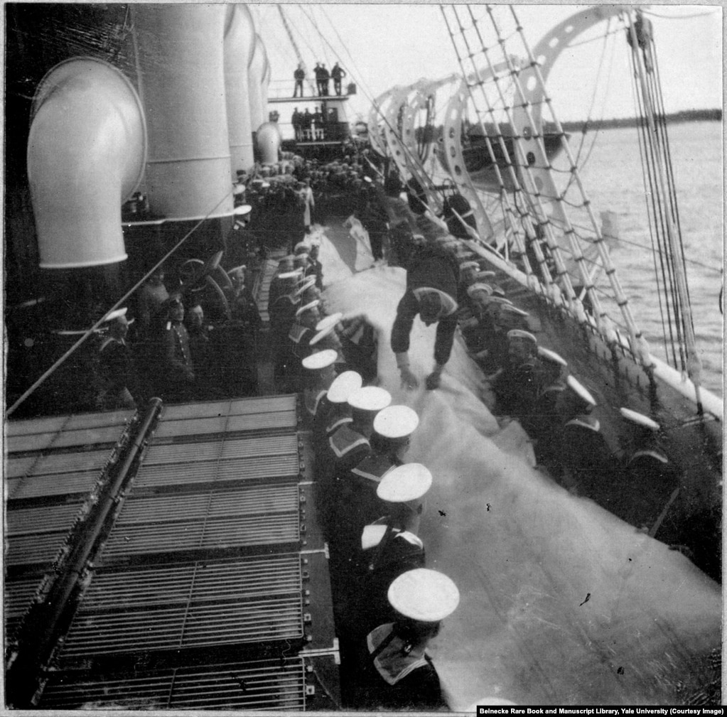 Aboard the Standart, sailors take turns bouncing their shipmates down the deck on mats.