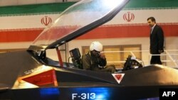 Iranian President Mahmud Ahmadinejad approaches the pilot of the Qaher F-313 during the unveiling ceremony. Experts question the quality of the material used to make the canopy.