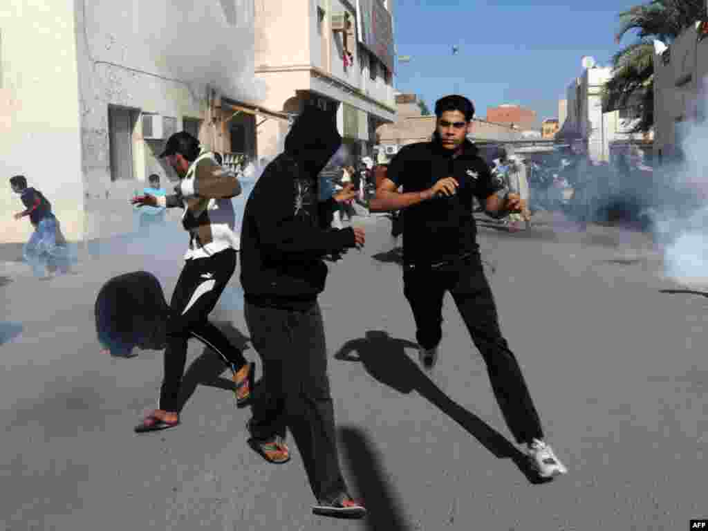 Bahraini protesters run for cover after police fired tear gas canisters to disperse them in the village of Diraz, northwest of Bahrain, on February 14, during a demonstration called for on Facebook and inspired by similar initiatives that led to the ouster of the regimes in Tunisia and Egypt. Photo by AFP