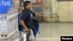 Mohammad Ajmal Kasab is pictured in Mumbai's main train station during the attacks.