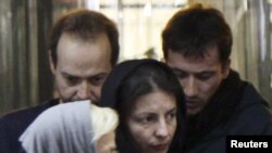 Jailed German journalists Marcus Hellwig and Jens Koch (back, left to right) were allowed to meet with relatives in Tabriz on December 28.