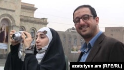 Armenia -- An Iranian couple takes pictures in Yerevan's Republic Square, 21Mar2011.