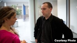 Sergei Maksimov, right, at a courthouse in Bonn. Maksimov was convicted August 5 of hacking Russian opposition leader Aleksei Navalny's email account.