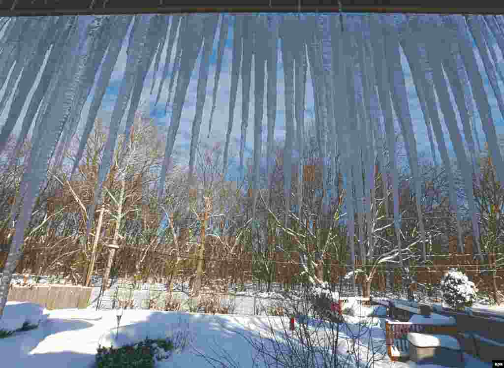 Icicles hang from the eaves of a house as temperatures sank to 0 degrees Fahrenheit (-17.7 C) in Wilmette, Illinois.