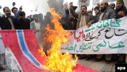 Supporters of an Islamic party in Pakistan in 2010 burn a Norwegian flag during a protest in Lahore against the republication of the controversial Muhammad caricatures.