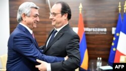 Poland -- French President Francois Hollande (R) greets Armenian Prime Minister Serzh Sargsyan (L) prior to bilateral talks on the sidelines of a NATO summit in Warsaw, Poland, on July 9, 2016.