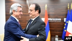 Poland -- French President Francois Hollande (R) greets Armenian Prime Minister Serzh Sargsyan (L) prior to bilateral talks on the sidelines of a NATO summit in Warsaw, Poland, on July 9, 2016.