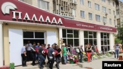 People carry a coffin with the body of Andrei Maksimenko, a salesman of the firearms shop that was a target of a recent suspected Islamist militant attack, in Aqtobe on June 8.