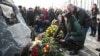 Mourners gather at a memorial to victims of the UIA plane crash at Kyiv's Boryspil Airport in February.