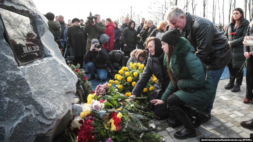 People lay flowers at the new memorial to the victims of Flight PS752 at Boryspil airport.