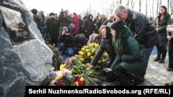 Mourners gather at a memorial to victims of the UIA plane crash at Kyiv's Boryspil Airport in February.