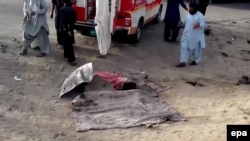 A dead body covered on the ground at the alleged scene of a drone strike that killed the Afghan Taliban's supreme leader, Mullah Akhtar Mansur, in the Ahmad Wal area of Balochistan on May 21.