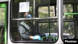 Armenia -- A masked commuter rides a bus in Yerevan, May 18, 2020.