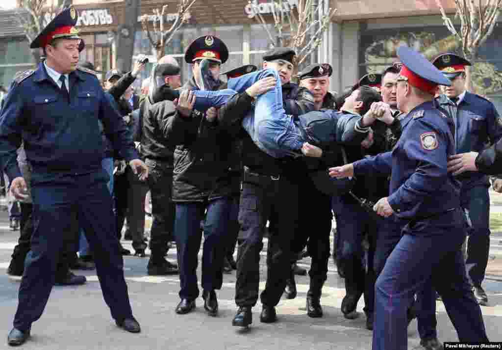 Police officers detain an anti-government protester during a rally in Almaty, Kazakhstan. Police detained dozens of people who were protesting the government&#39;s move to rename the Central Asian nation&#39;s capital after former President Nursultan Nazarbaev, just days after his surprise resignation. (Reuters/Pavel Mikheyev)
