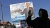 An electoral billboard goes up for a Serbian-minority party in Gracanica.