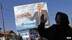 An electoral billboard goes up for a Serbian-minority party in Gracanica.