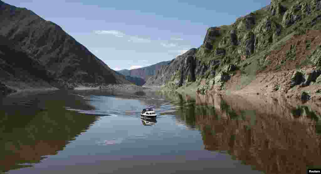 A patrol boat cruises along the Yenisei River in Russia's Sayano-Shushensky nature reserve. (Reuters/Ilya Naymushin)