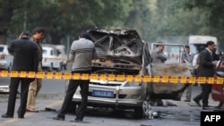 Investigators work at the site where a vehicle exploded near the Israeli Embassy in New Delhi on February 13.