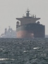 FILE PHOTO: Cargo ships in the Gulf, near the Strait of Hormuz