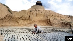 A 10-year-old boy works at a brick factory on the outskirts of Kabul. (file photo)
