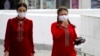 Turkmen women are seen wearing face masks in Ashgabat on July 13, where they had been banned just 2 week before.