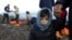 Greece -- A Syrian refugee child looks on, moments after arriving on a raft with other Syrian refugees on a beach on the Greek island of Lesbos, January 4, 2016