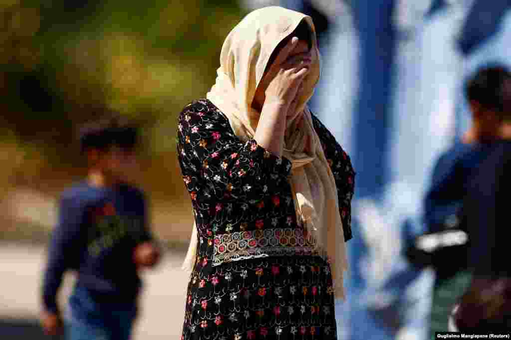 An Afghan evacuee stands at a holding center run by the Italian Red Cross in Avezzano, Italy, on August 30. After their travels, the evacuees there are waiting out their quarantine for COVID-19.