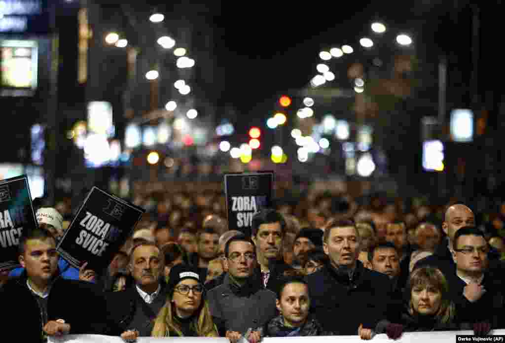 People march down a street toward a memorial service marking the 16th anniversary of the assassination of the first democratic prime minister, Zoran Djindjic, in Belgrade on March 12.&nbsp;(AP/Darko Vojinovic)