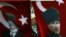 A woman wearing a traditional head scarf is framed by Turkish flags depicting the founder of modern Turkey in Istanbul. (file photo)