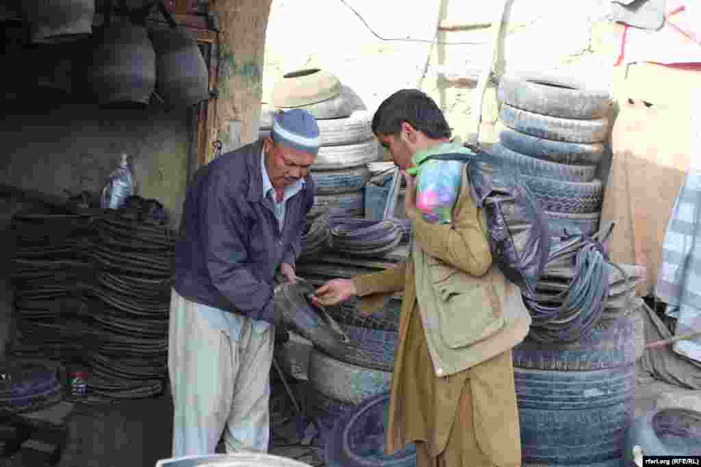 Afghanistan -- making rubber bucket, string, chair and table from used car tires in Kabul, 29 November 2015 