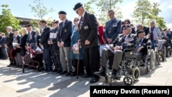 British veterans observe two minutes of silence at an event to commemorate the 75th anniversary of D-Day in Alrewas, Staffordshire, Britain, in 2019.