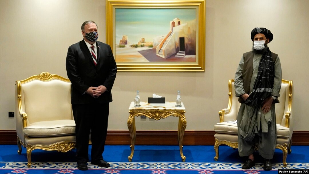 U.S. Secretary of State Mike Pompeo (left) meets with Mullah Abdul Ghani Baradar, head of the Taliban's peace negotiation team, amid talks between the Taliban and the Afghan government, in Doha on November 21, 2020.