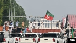 Supporters of former Prime Minister Imran Khan's Pakistan Tehreek-e-Insaf party block a road during a protest in Islamabad on October 5, 2024.