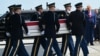 US President Donald Trump salutes as a US Army carry team carries a flag-draped transfer case during an event for US service members killed during operations in the Middle East, in Dover, Delaware, on July 22.