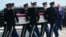 US President Donald Trump salutes as a US Army carry team carries a flag-draped transfer case during an event for US service members killed during operations in the Middle East, in Dover, Delaware, on July 22.