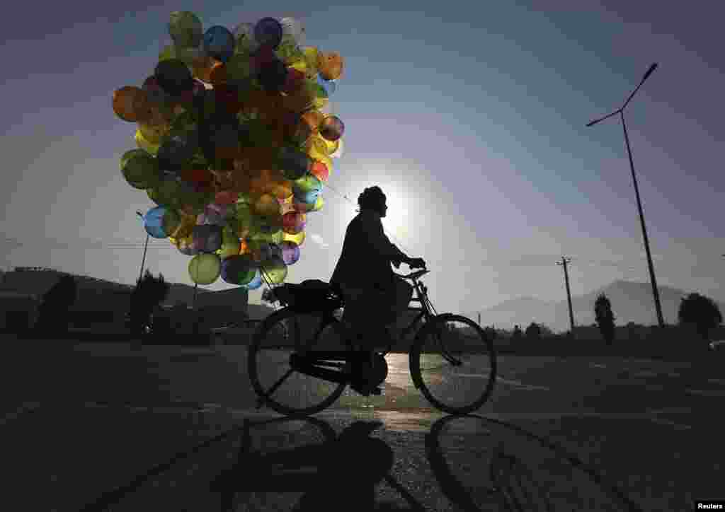 A balloon vendor rides his bicycle in Kabul. (Reuters/Omar Sobhani)