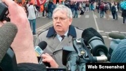 A photoshopped image of U.S. Ambassador to Russia John Tefft allegedly attending an antigovernment rally in Moscow. REN-TV later admitted the image was a fake.