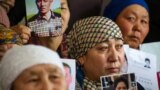 Petitioners with relatives missing or detained in Xinjiang hold up photos of their loved ones during a press event at the office of the Atazhurt rights group in Almaty, Kazakhstan, on January 21, 2019.