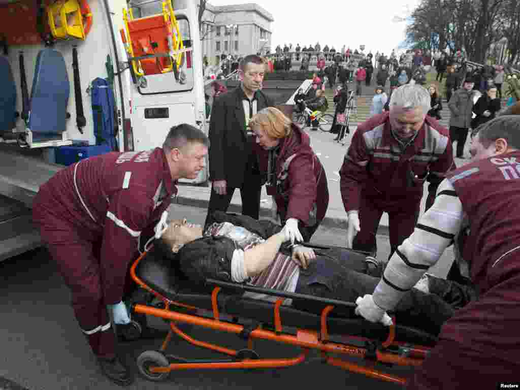 Medics lift a victim of the blast into an ambulance.