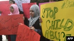 FILE: Pakistani protestors carry placards during a demonstration against the rape and murder of a child in the eastern city of Lahore in January 2018