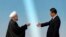 China -- Iranian President Hassan Rohani (L) is greeted by his Chinese counterpart Xi Jinping before the opening ceremony of the fourth Conference on Interaction and Confidence Building Measures in Asia summit in Shanghai, May 21, 2014